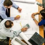 Workers gathered around a desk