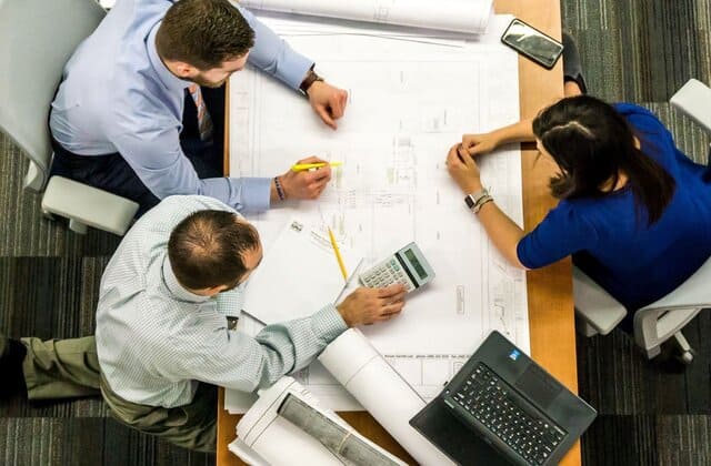 Workers gathered around a desk