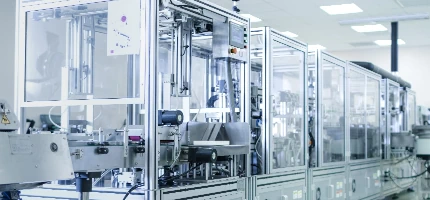 Modern industrial machinery in a clean manufacturing facility with a blurred background.