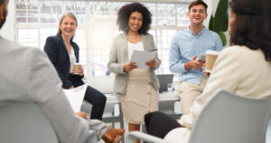 Team members participating in a workplace coaching and mentorship discussion